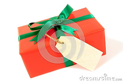 Small red christmas or birthday gift with green ribbon bow, gift tag or label, isolated on white background Stock Photo