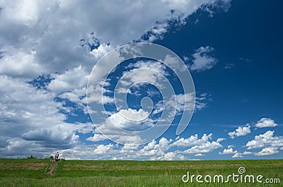 Small red figure in a vast cloudy blue Expanse Stock Photo