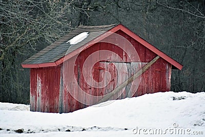 Small Red Outbuilding Barn in the Snow Stock Photo