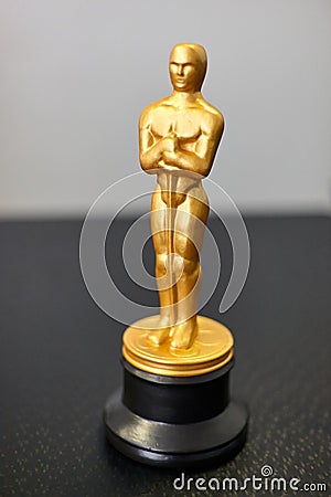 A small replica of the Oscar figure. A symbol of achievements in cinema. Selective focus Editorial Stock Photo