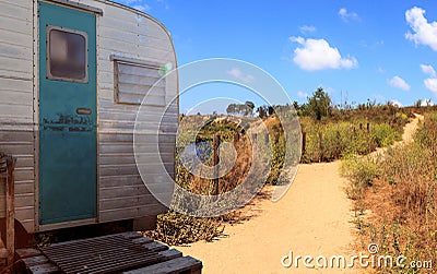 Small retro caravan camper used as a tiny house on road trips Stock Photo