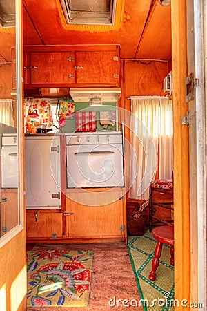 Small retro caravan camper used as a tiny house on road trips Stock Photo