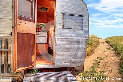 Small retro caravan camper used as a tiny house on road trips Stock Photo