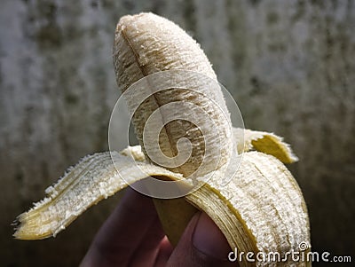 Small ripe opened banana ready to eat Stock Photo