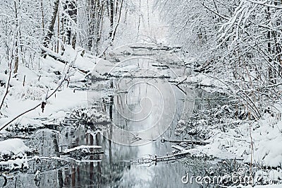 Small river in dreamlike snowy forest Stock Photo