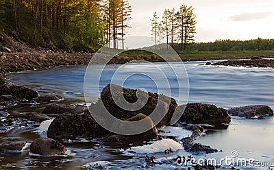 Small river with dynamic water and stones on the foreground Stock Photo