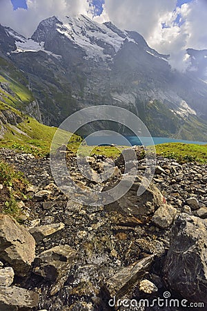 Small river flowing to the lake. Oeschinensee, Kandersteg. Berner Oberland. Switzerland Stock Photo