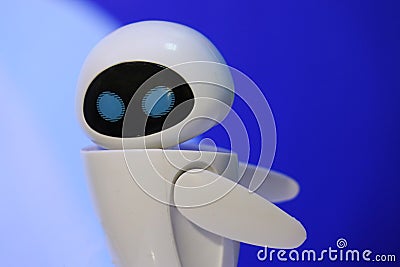 A small robot with a humanoid body on a blue background . Artificial intelligence-AI. Blue-white robot. Editorial Stock Photo