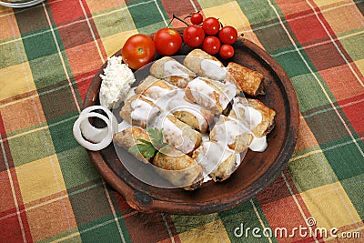 Small rolled pies with sour cream Stock Photo