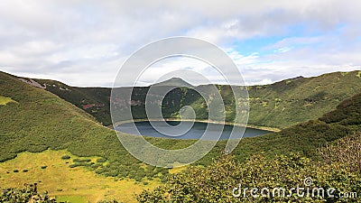 Small round lake inside the crater of the extinct volcano. Kamchatka Peninsula, Russia Stock Photo