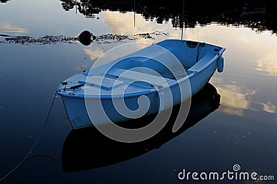 Small rowing boat on calm water Stock Photo