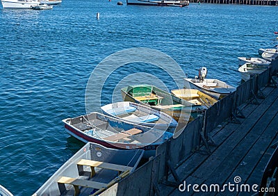 Small rowing boats tied to a dock area Stock Photo