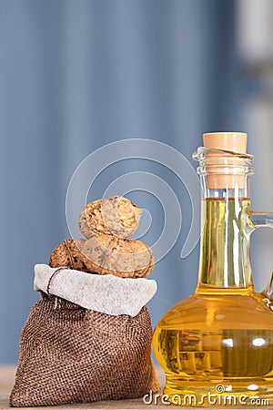 Small sacks filled with walnuts and a bottle of walnut oil Stock Photo