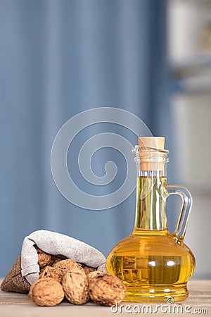 Small sacks filled with walnuts and a bottle of walnut oil Stock Photo