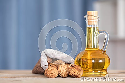 Small sacks filled with walnuts and a bottle of walnut oil Stock Photo