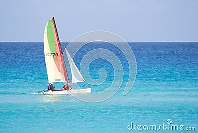 Small sailboat in a calm blue sea Stock Photo