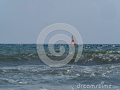 Small sailing boat in the waves of the rough sea Stock Photo