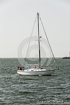 Small sailing yacht near the caostline Stock Photo