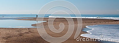 Person on small sandbar where the Pacific ocean and the Santa Clara river meet at Surfers Knoll beach in Ventura California USA Stock Photo