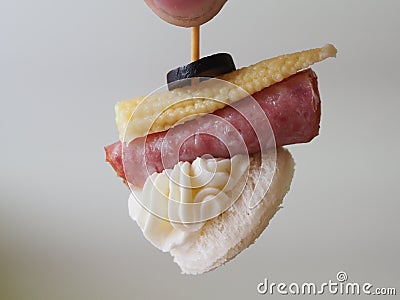 Small sandwiches on toothpicks canapes in hand Stock Photo
