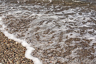 A small sea wave runs ashore Stock Photo