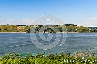Small settlement on the Bank of a wide river Stock Photo