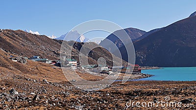 Small Sherpa village Gokyo (4,860 m), Himalayas, Nepal located on the shore of turquoise colored third lake. Stock Photo