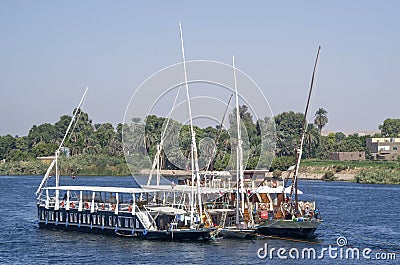 Small ships with sails for tours on the Nile river, Egypt Editorial Stock Photo