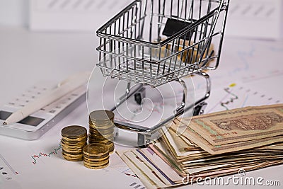 Small shopping cart on stock market charts Stock Photo