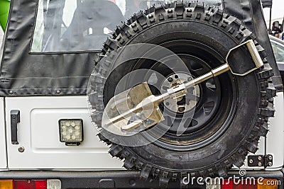 Small shovel and spare wheel in an off-road vehicle. Stock Photo