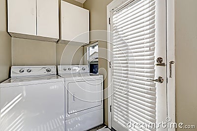 Small and simple laundry room with old-fashioned appliances Stock Photo