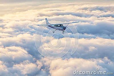 Small single engine airplane flying in the gorgeous sunset sky Stock Photo