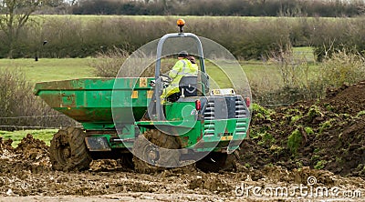 A small site dumper truck tipping load Editorial Stock Photo