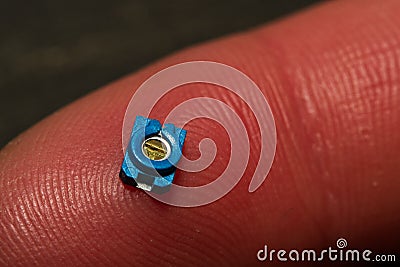 Small SMT Trim Pot Resistor Component On Finger Stock Photo