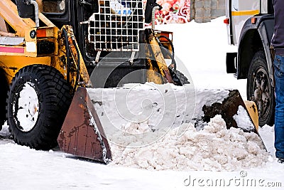 Small snow plow tractor. Snow Cleaner. Winter road works Stock Photo