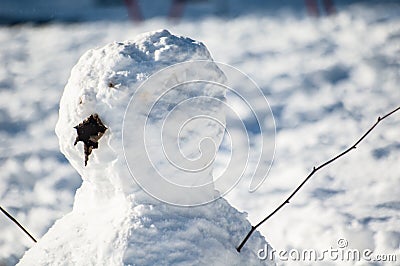 Small snowman in Cutts Close Park, Oakham, Rutland Stock Photo