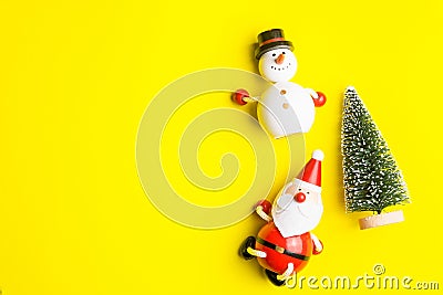 Small snowman and Small Santa Claus on yellow background at Christmas day.Theme Christmas day background. Stock Photo