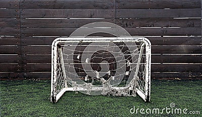 Small soccer goal with old net in the playground for children. Stock Photo