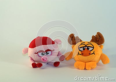 Small soft children`s toys depicting a baby pig and moose. The picture was taken in close-up. Stock Photo