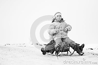 Small southern romanian village. Scenes from a moody winter with children playing with sledges and enjoying the snow Editorial Stock Photo