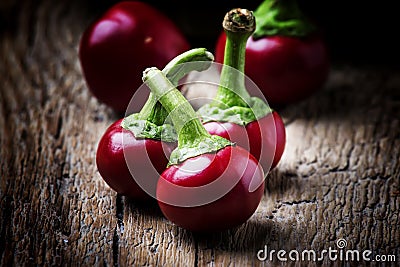 Small spicy red pepper, vintage wooden background, selective focus Stock Photo