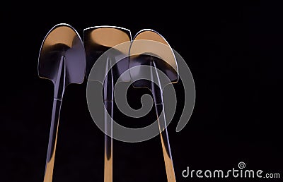 Small stainless steel spades used for spoons and for miniature gardening tools Stock Photo