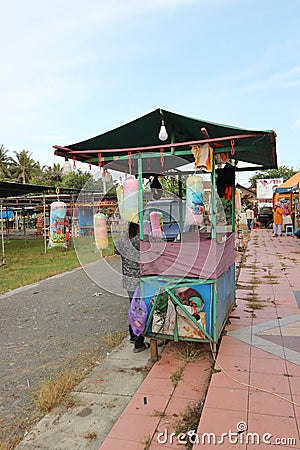 A small stall selling cotton candy snacks in a city park Editorial Stock Photo