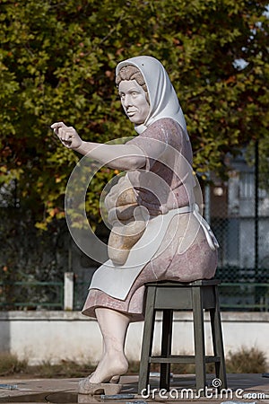 Small statue of a working lady on Portimao city Editorial Stock Photo