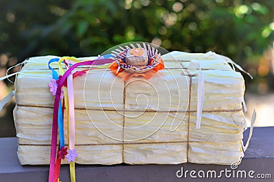 Small straw hat with colorful ribbons on the fake hay bale Stock Photo