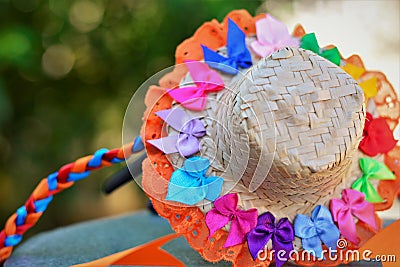 A small straw hat filled with small colored ribbons and lace and ribbon braid Stock Photo