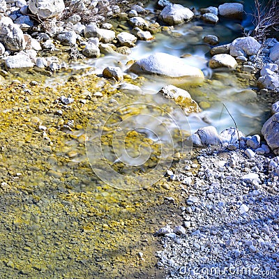 Small stream in spring, smooth rocks smoothed by the water Stock Photo