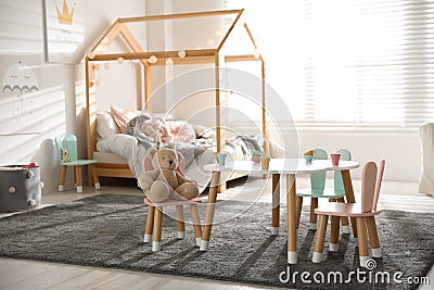 Small table and chairs with bunny ears in children`s bedroom Stock Photo