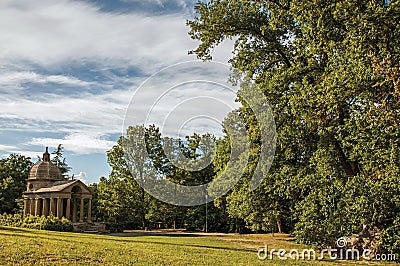 Small temple at sunset amidst the vegetation in Bomarzo Stock Photo