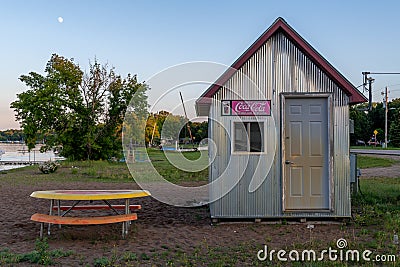 Small tin building for selling refreshments at a public beach on Ottertail Lake in Mi Editorial Stock Photo